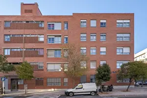 Townhouse Prints: Facade of a residential building built with brown bricks and tree grates on the street
