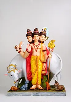 Three face God Shri Gurudev Datta Dattatreya Dattaguru with cow and dogs clay statue sculpture Lord Brahma Vishnu and Shiva in one single form India