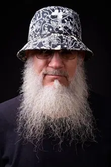 Eccentric Prints: Face of mature handsome bearded man wearing bucket hat