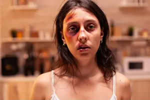 Grief Prints: Face of scared woman victim in home after being abused because of agressive
