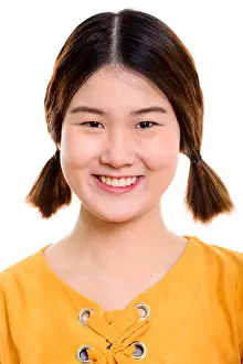 Tied Prints: Face of young happy Asian woman smiling with pigtails