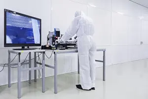 Glove Prints: A factory worker in a white lab suit
