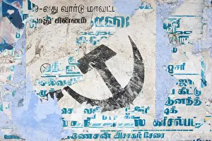 Directing Prints: faded communist hammer and sickle on wall poster in India
