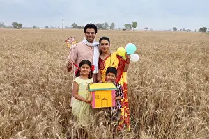 Villager Prints: Family showing dream home and smiling