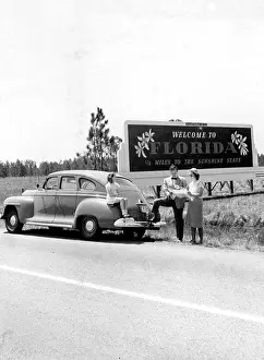 Billboards Prints: A family stops to look at a map near the Florida welcome sign