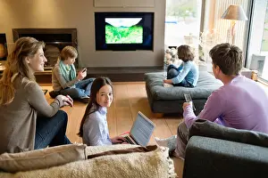 Remote Control Prints: Family using electronic gadgets in a living room