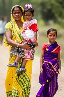Daughters Prints: A family walks together in Pan Bari Village in the Kaziranga National Park in India on the 13th April 2016