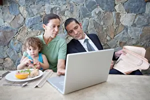 Family With One Child Prints: Family working at breakfast table