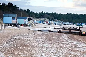 The famous beach huts at Wells-next-the-Sea snow covered in winter North Norfolk UK