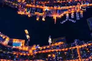 Fantastic aerial evening cityscape of Klaksvik town with glowing pier, ships and boats, Bordoy island, Faroe islands, Denmark. Landscape photography