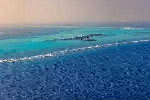 Fantastic aerial landscape, luxury tropical resort or hotel with water villas and beautiful beach scenic. Amazing bird eyes view in Maldives landscape
