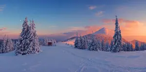 Fantastic orange evening landscape glowing by sunlight. Dramatic wintry scene with snowy trees. Carpathians, Ukraine, Europe. Me