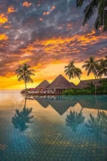 Images Dated 1st November 2019: Fantastic poolside, sunset sky, palm trees reflection. Luxury tropical beach landscape