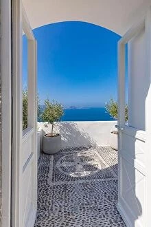 Images Dated 12th October 2019: Fantastic travel background, Santorini urban landscape. White door or gate with stairs