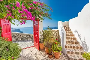 Fantastic travel background, Santorini urban landscape. Red door, gate with stairs white architecture under blue sky. Idyllic summer vacation luxury
