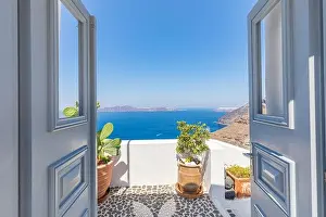 Fantastic travel background, Santorini urban street landscape. Blue door or gate stairs and white architecture under sunny sky. Amazing summer vacay