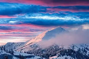 Fantastic winter landscape in snowy mountains glowing by morning sunlight. Dramatic wintry scene with frozen snowy trees at sunrise