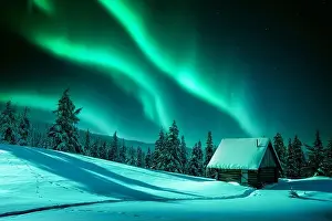 Boreal Prints: Fantastic winter landscape with wooden house in snowy mountains and northen light in night sky