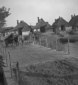 A farmer leads a horse-drawn carriage over a bridge at a village on the Baltic coast in Pomerania (Kamp or Deep)
