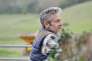 Leaning Prints: Farmer leaning on fence in field looking out
