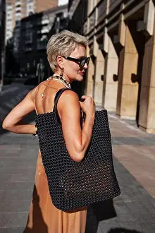 Handbag Prints: Fashionable Blonde Woman with Short Hair in stylish outfit with black woven bag