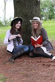 Glamorous Prints: two fashionable teenagers bird watching with guide and binoculars