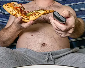 Lazy Prints: Fat man eating pizza and using TV remote, unhealthy lifestyle concept