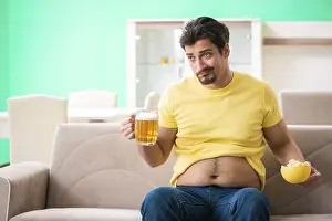 Abdomen Prints: Fat obese man holding beer in dieting concept