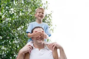 Mid Adult Man Prints: Father carrying son on his shoulders