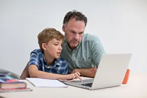 Supportive Prints: Father helping son with homework