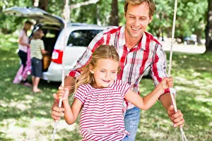 Mid Adult Woman Prints: Father pushing daughter on swing