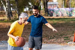 Guys Prints: Father and son playing basketball in the park