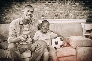 Homey Prints: Father and son watching tv together on the couch