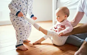 Bedtime Prints: Father and toddler children sitting on the floor at home at bedtime
