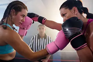 Boxer Prints: Female boxers punching each other at boxing ring at fitness studio