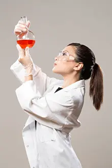 25 30 Years Prints: Female Chinese Healthcare professional or scientific researcher looking at a row of test tubes