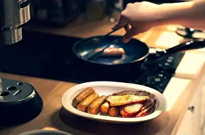 Hot Dog Prints: Female cooking breakfast on kitchen counter bar.Healthy food, simple eating lifestyle