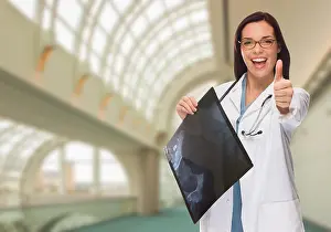Latina Prints: Female Doctor or Nurse With Thumbs Up Holding X-ray Standing Inside Hospital