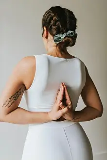 Mid Adults Prints: Female fitness instructor with hands clasped behind back doing yoga at health club