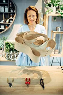 Wrap Prints: Female florist holds decorative birch bark in flower shop