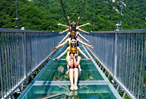 Graduate Prints: Female graduates dressed in bikinis pose for graduation photos on the glass bridge at the Tianlongchi scenic area