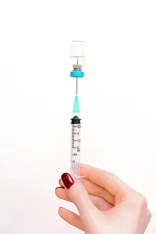 Vaccine Prints: Female hand holding injection syringe with medicine vial