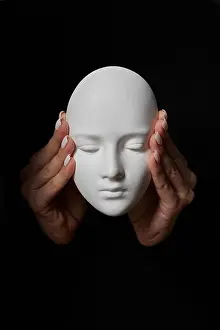 Hear Prints: Female hands close ears of plaster mask face on a black background