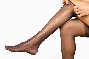 Weave Prints: Female legs with a ripped pantyhose on