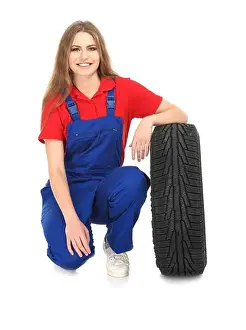 Replacement Prints: Female mechanic in uniform with car tire on white background