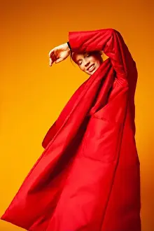 Slim Prints: Female model in baggy coat and dancing
