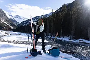 Fourties Prints: A female puts skins on her skis in the Canadian backcountry