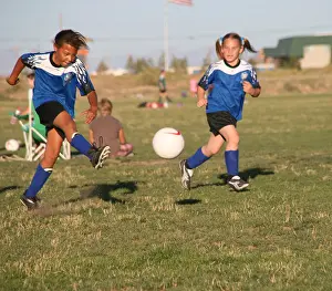 Blond Hair Prints: Two female soccer players playing soccer game