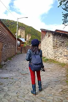 Vertical Image Prints: Female Traveler Climbing up to the Hill Leading to Medieval Svan Tower-house