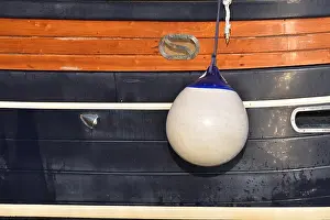 Illuminator Prints: A Fender (boating) hanging on the board to protect the side of the sailing vessel from the damage